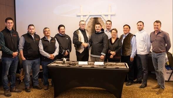 Baffinland Iron Mines Corporation president and CEO Brian Penney, centre left, is pictured with P.J. Akeeagok, president of the QIkiqtani Inuit Association, following the signing of the amended Mary River Project Inuit Impact Benefit Agreement. The Amended Agreement includes new programs and commitments to maximize Inuit involvement at the Mary River Mine. Photo courtesy of Baffinland Iron Mines.