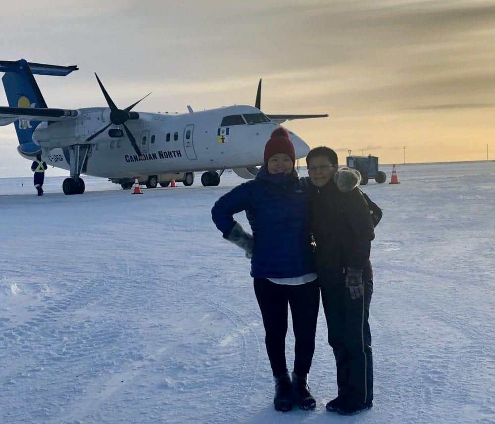 Rhoda Angutimarik, left, CEO of Arctic Fresh, and Akittiq Angutiqjuaq, volunteer director for the Igloolik Food Bank, meet a plane carrying approximately $10,000 worth of donated food for people in the community. photo courtesy of Merlyn Recinos