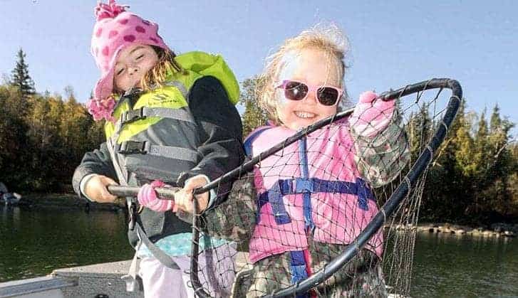 Alexie Bryant, the Duchess of Squishy Pets, and Arizona of Gregory, winner 2018 annual Yellowknifer Catch of Week contest, shows off their mighty catch of sparkly whitefish while on a journey to Prosperous Lake earlier this month. The whitefish was caught using a magic, pink wire jewel bug. Mike W. Bryant/NNSL photo.