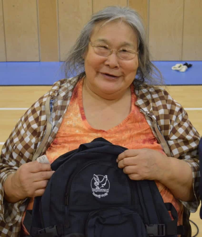 Martha Pooyatak holds a Qiqirtaq Snowy Owls backpack that she won in a draw. She was one of the elders who shared her wisdom with the students. 