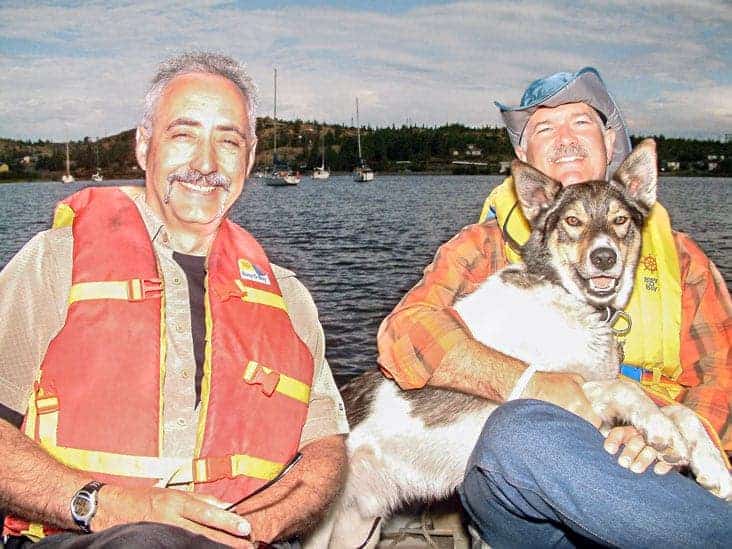 Skipper, the Fishin' Technician's sidekick for the past 15 years, accepts a cuddle from the late Jack Layton, leader of the federal New Democratic Party, during a day's fishing with former Western Arctic MP Dennis Bevington in 2006. Skipper died Sunday after a lifetime of fishin' with all kinds of Technician guests, famous or otherwise. NNSL file photo