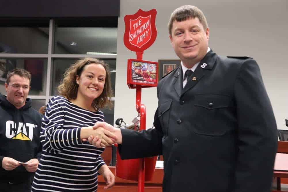 Mayor Rebecca Alty, left shakes Jason Brinson, Corps Leader, Salvation Army's hand after making the first donation of 2018. Dylan Short/NNSL photo