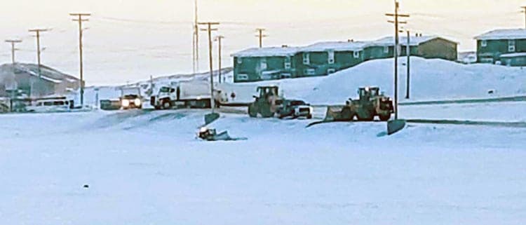 Hamlet vehicles block the road as two front-end loaders arrive to try and pull out a hamlet CAT bulldozer that crashed through the ice on Williamson Lake in Rankin Inlet on Nov. 15, 2018. Darrell Greer/NNSL photo
