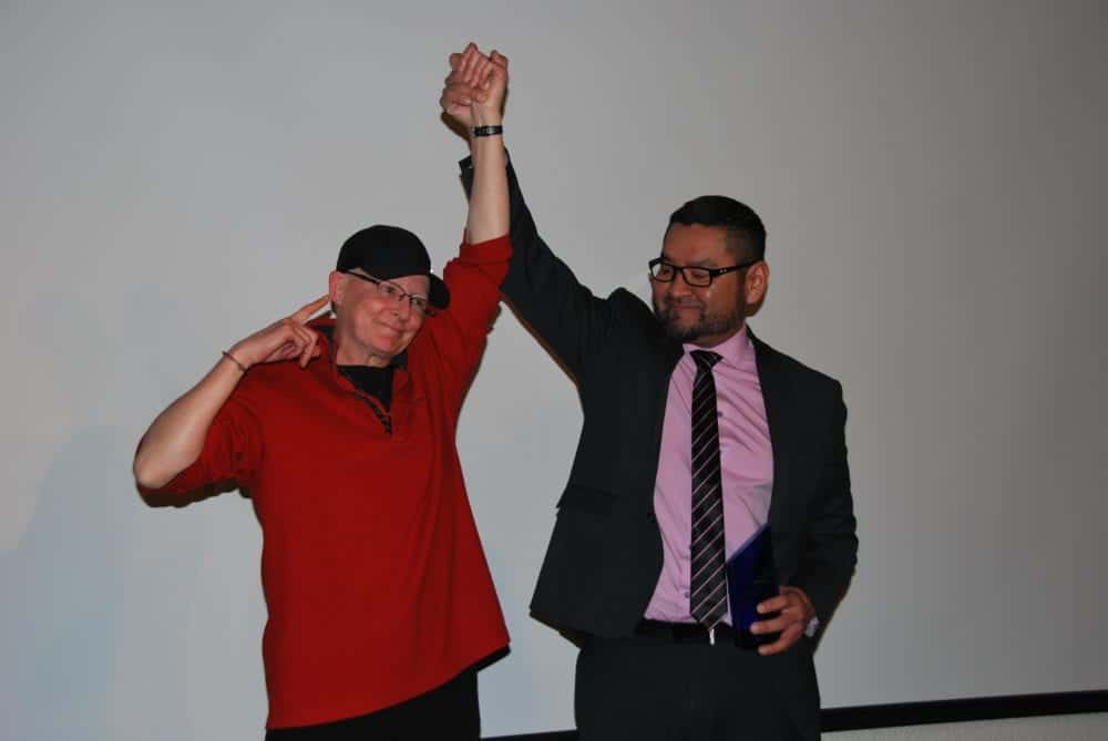 Robin Mercer-Sproule, left, has her hand raised triumphantly by Alfred Moses, Minister of Municipal and Community Affairs, after she was inducted into the athletes category of the NWT Sport Hall of Fame at the Explorer Hotel on Nov. 23. James McCarthy/NNSL photo