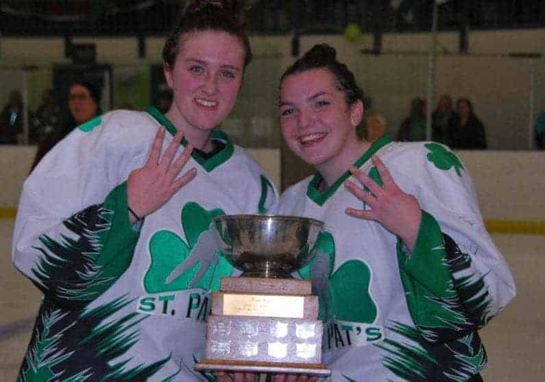 Sarah Fleming, left, captain of the St. Pat's girls team, and Katie Hart are all smilles as they show off how many times they've won the Wade Hamer Challenge Cup girls title as teammates – four – after they won the girls game on Wednesday over Sir John Franklin at the Multiplex. James McCarthy/NNSL photo