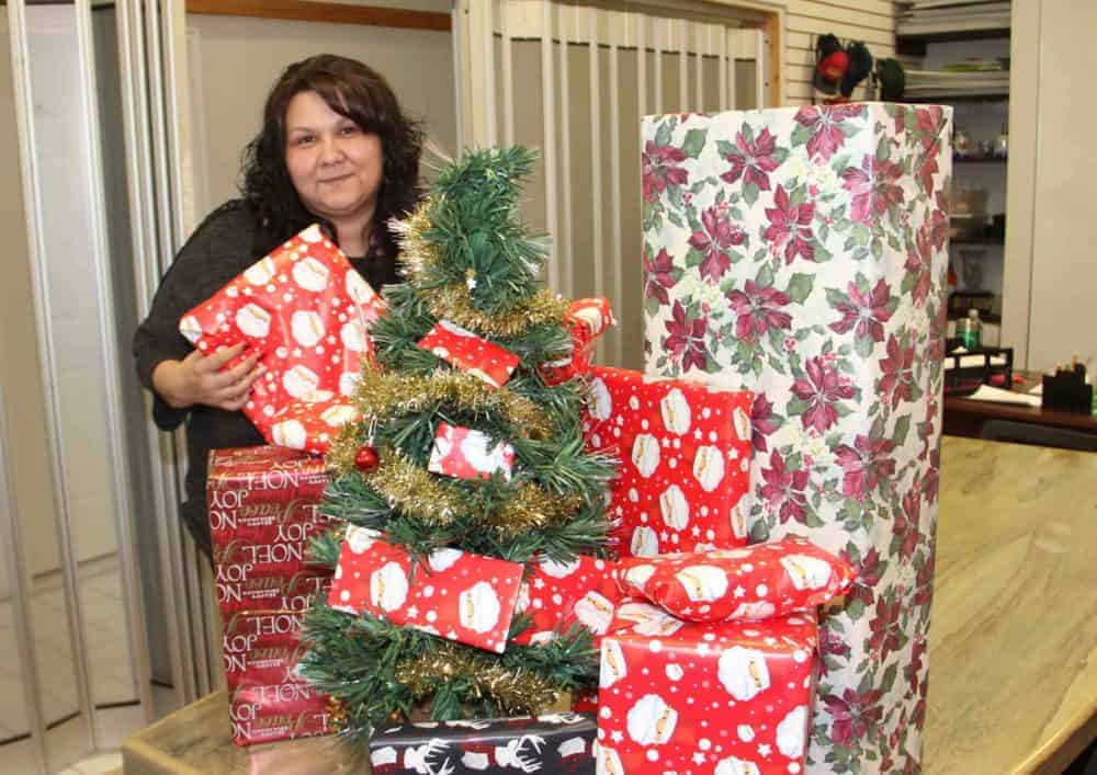 Jacqueline Boyce, the executive assistant with the Hay River Chamber of Commerce, displays some of the prizes in the organization's new Christmas contest called Santa's Sleigh of Surprises. Paul Bickford/NNSL photo