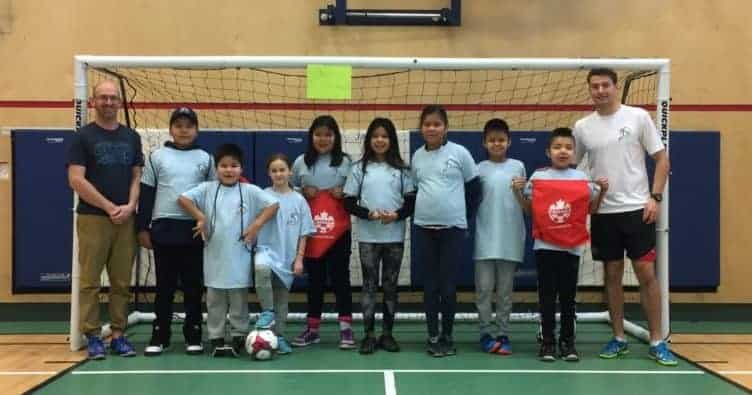 Tim Wooldridge, left stands with  Joseph Koyina, Jaycee Wedawin, Jacqueline Willard, Ade Zoe, Nika Mantla-Arrowmaker, Hannah Bekale, Keyden Quitte, Taati Lamouelle and Jesse Mcniven at the Gameti futsal camp. photo courtesy of Tim Wooldridge