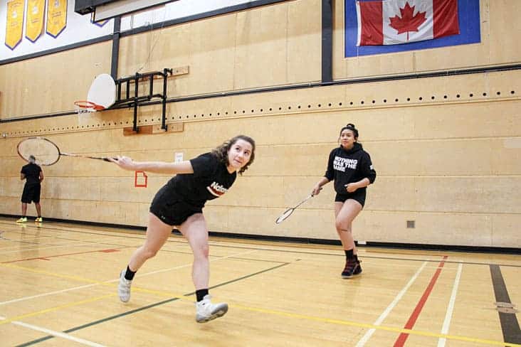 Ashley Matesic, left returns the birdie as teammate Jackie Ramirez watches on. photo courtesy of Jeremy Kielstra