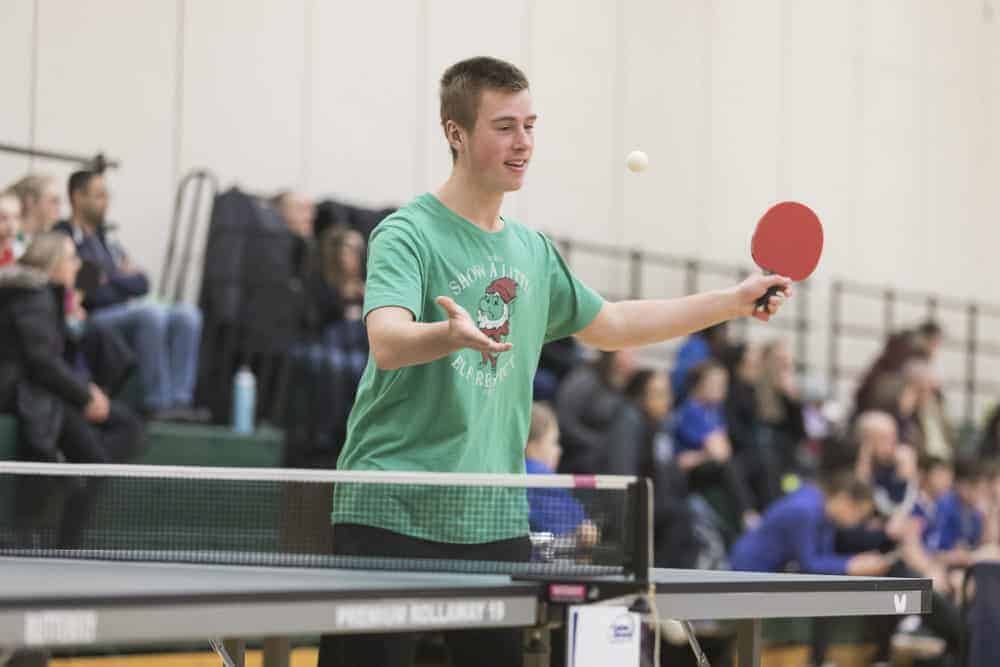 Nathan Cluff serves the ball during men's singles action at the NWT School Championships. photo courtesy of Thorsten Ghol