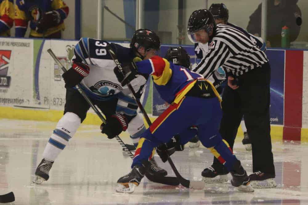 Andrew Carr looks to win a face off against Team Nunavut's Chase Herron. Dylan Short/NNSL photo