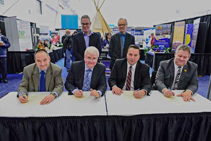 photo courtesy of Ryan McLeod Industry, Tourism and Investment Minister and Health Minister Glen Abernethy sign a socioeconomic agreement with Fortune Minerals, proponents of the NICO project outside of Whati.