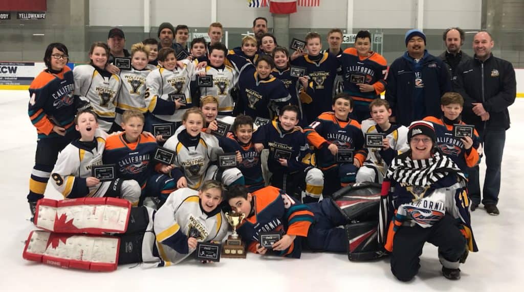 The players from the Yellowknife Wolfpack peewee development team and California Wave gather together for the customary group shot following their joint game at the Vernon Winter Carnival Coca-Cola Classic Tournament in Vernon, B.C., on Feb. 10. Both teams split their players into two new outfits with new names after the Wave had to send players back home for a playoff game. photo courtesy of Darren Wicks