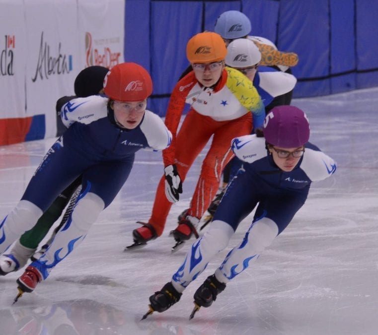 Emma Carpenter (in orange helmet cover) prepares to go into a turn during her heat in the girls 1,500-metre event at the Canada Winter Games in Red Deer, Alta., on Feb. 17. Jerrold Leblanc/Canada Winter Games photo