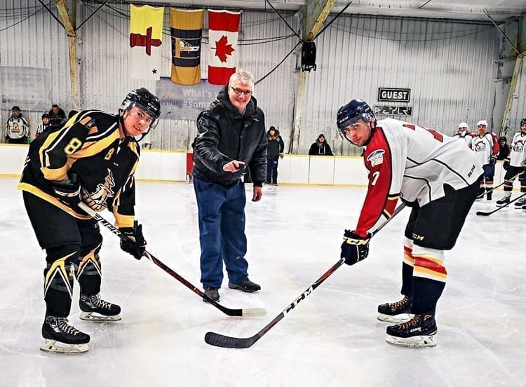 Jim MacDonald drops the puck between Sidney Nichol of the Rankin Rock and Andrew Pearce of the Baffin Blizzard to mark the championship game of the Polar Bear Plate juvenile-junior tournament in Rankin Inlet on Feb. 17, 2019. Photo courtesy Noel Kaludjak