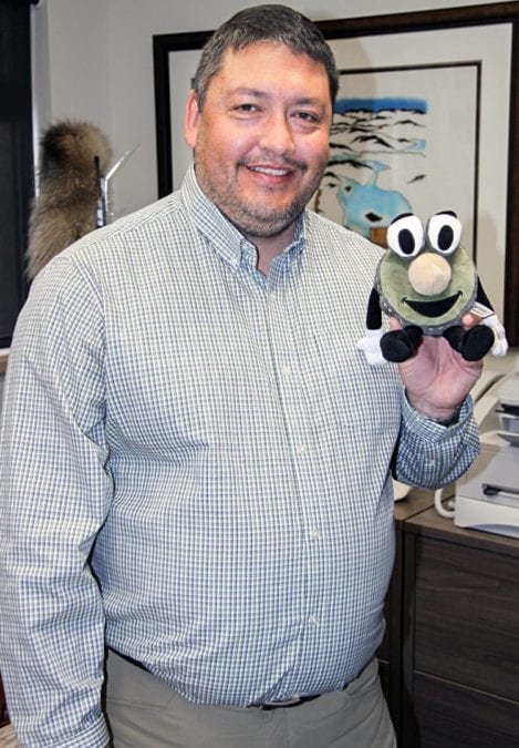 Kivalliq Inuit Association president David Ningeongan displays a mascot that shows the actual size of the proposed hydro and fibre optics link to Manitoba, with the face of the mascot representing the size of the actual cable and the mascot's nose the size of the fiber inside in Rankin Inlet on Nov. 2, 2018. NNSL file photo