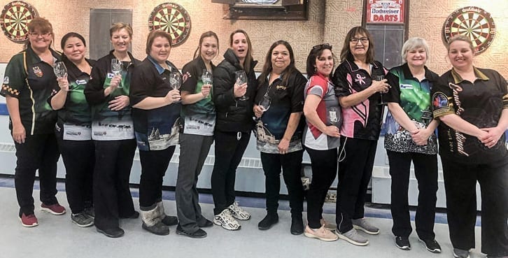 The top women's players from the NWT Darts Championships in Hay River show off their trophies following the completion of the tournament this past Sunday. They are, from left, Brenda Moreau (Fort Simpson), Sam Antoine (Hay River), Michelle Smith (Hay River), Sam Bohnet (Yellowknife), Tanya Ruben (Inuvik), Angela Carter (Hay River), Joy Cathers (Inuvik), Kim Squires-Rowe (Hay River), Gloria Allen (Inuvik), Kathy Hancock (Yellowknife) and Jen Lavers (Yellowknife). photo courtesy of Randy Thompson