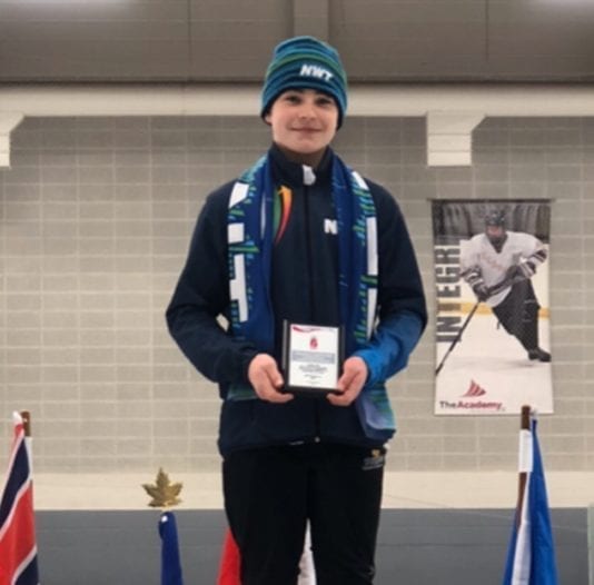 Sage Acorn stands atop the podium with his championship plaque after he won the overall title in the T2T 12 boys division at the Canada West Short Track Championships in Grande Prairie, Alta., on Sunday. photo courtesy of Kerry Egan