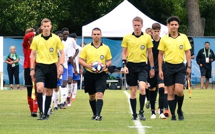 Nick Rivet, second from left, walks on as part of the officiating crew prior to the start of action at the Western Canada Summer Games in Swift Current, Sask., on Aug. 10. Rivet became the first-ever NWT soccer referee to have an on-field role at the Games. photo courtesy of 2019 Western Canada Summer Games
