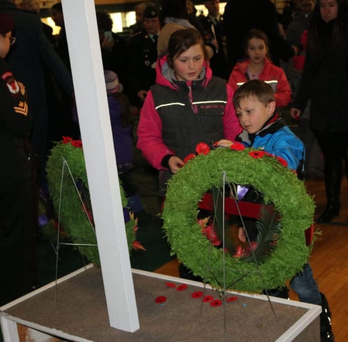 Laying poppies at the cross. Simon Whitehouse/NNSL photo