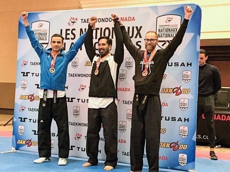 Kevin Cull, right, shares the spoils as the bronze medalist in the solo poomsae under-40 division with silver medalist Reza Rabiei of Ontario, left, and gold medalist Timothy Johl of Ontario at the Canadian National Taekwondo Championships in Laval, Que., earlier this month. photo courtesy of Elaine Gillespie
