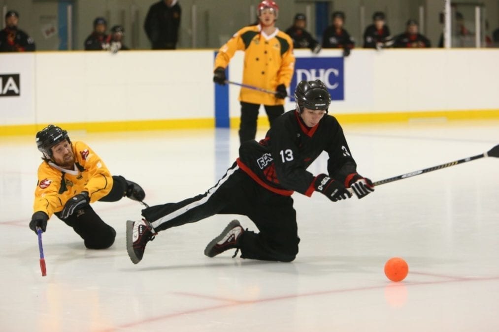 Dominic Debogorski, right, of the Ravens is all in as he attempts to put one past a Calgary Cowboys defender in the men's gold medal game at the 2014 World Broomball Championships in Japan. The Ravens would go on to win the game and the title. photo courtesy of Curtis Debogorski