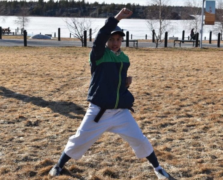Victor Lumacad practises his upper blocks during warm-ups as part of an outdoor class held by the Yellowknife Wado Kai Karate Club at Somba K'e Park on May 12. The club is back to its regular schedule after being off for two months due to Covid-19. Blair McBride/NNSL photo