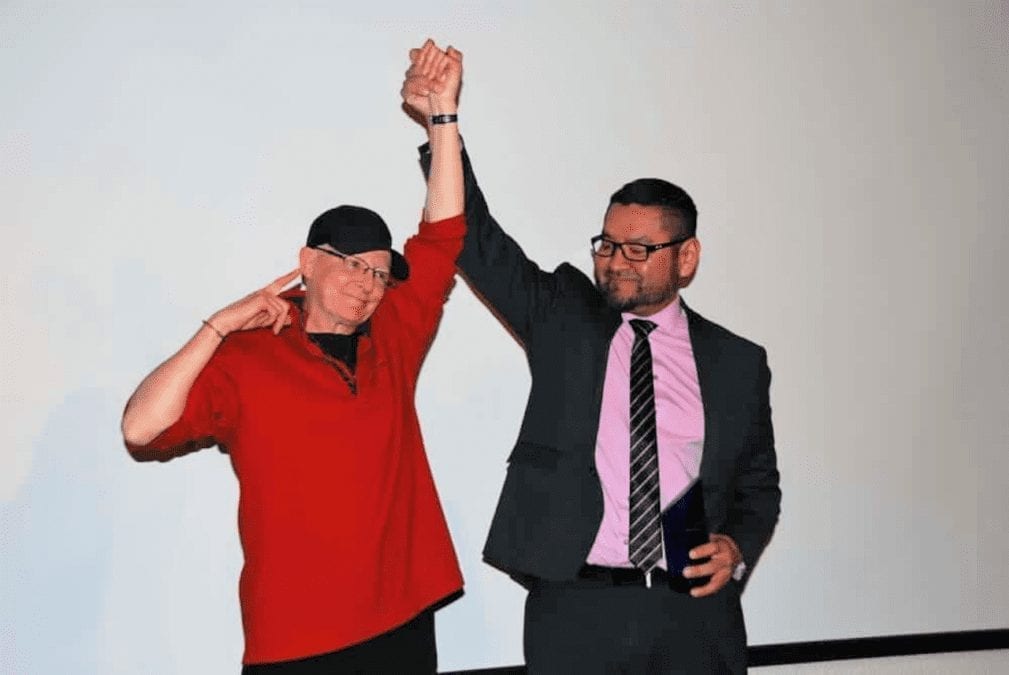 Robin Mercer-Sproule, left, raises her hand raised triumphantly with Alfred Moses, then-minister of Municipal and Community Affairs, after she was inducted into the athletes category of the NWT Sport Hall of Fame at the Explorer Hotel on Nov. 23, 2018. NNSL file photo