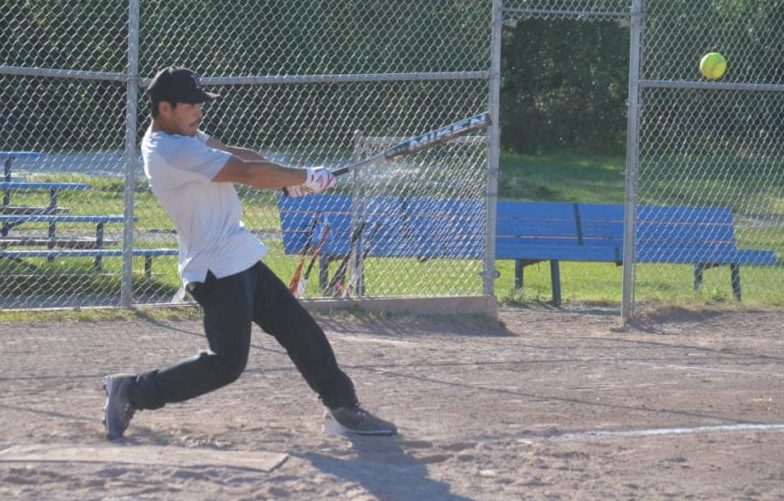 Byron Kototak of the Deton Cho Sluggerz muscles one into play during the opening night of the Yellowknife Slopitch Association's 2020 season at Fritz Theil Field on Sunday. James McCarthy/NNSL photo