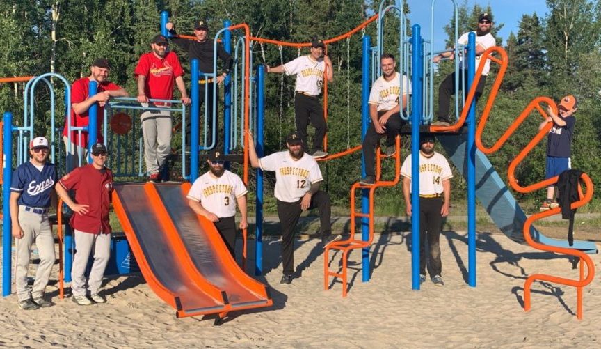 The new playground at Tommy Forrest Ball Park is officially open for business and is the final piece of the park's revitalization. Enjoying the park are, bottom row from left, Cameron MacIsaac, Jeff Hipfner, Dustin Hauber, Steve Thomas, Gavin McAndrews and Jaxon Melanson; top row from left, Garrett Hinchey, Chris Cahoon, Barry Bessette, Todd Sasaki, Rob Koehler and Jason Melanson. photo courtesy of Yellowknife Fastball League