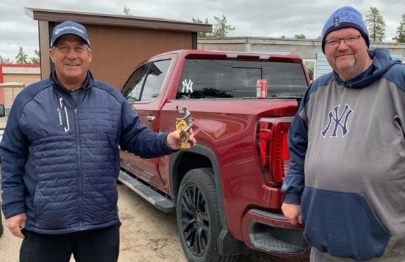 Daryl Snow, left, accepts the Mediocre Golf Association's top money-winner trophy from chapter president Shaun Morris following the final tournament of the season, The Last Gasp, at the Yellowknife Golf Club on Sunday. photo courtesy of Shaun Morris