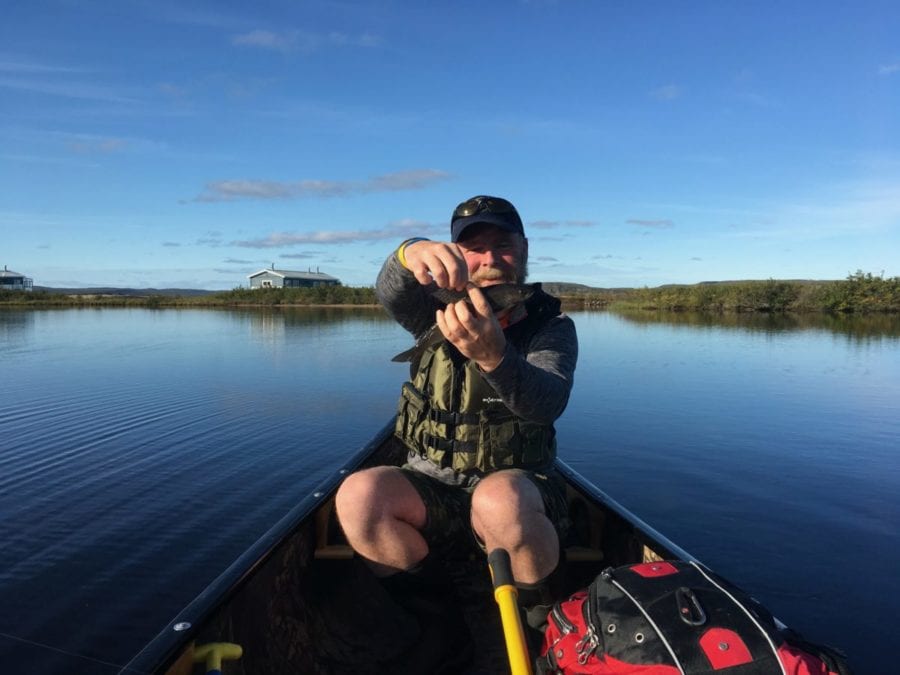 John MacEachern holds an Arctic Grayling he caught in Point Lake by Peterson's Point Lake Lodge. photo courtesy of Peterson's Point Lake Lodge
