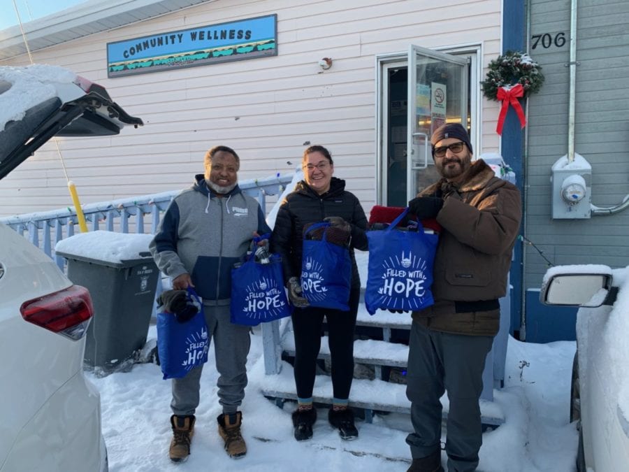 Abdi-Kareem Yalahow, left, a member of the executive committee of the Islamic Centre of Yellowknife (ICYK) gives winter warmth and hygienic kits to Jennifer Drygeese, director of community wellness with the Yellowknives Dene First Nation, along with Nazim Awan, chair of the ICYK, on Monday. photo courtesy of YKDFN