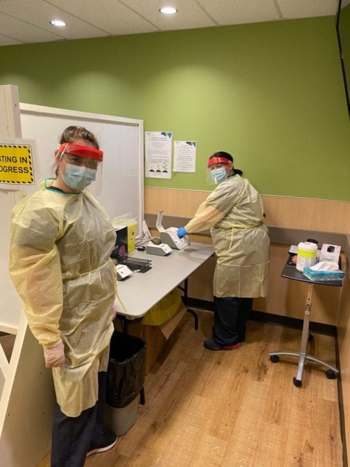 Tracey Foster DeBaie, left, and Jessica Jonasson use an ID Now device in the Yellowknife Covid clinic. photo courtesy of the Northwest Territories Health and Social Services Authority