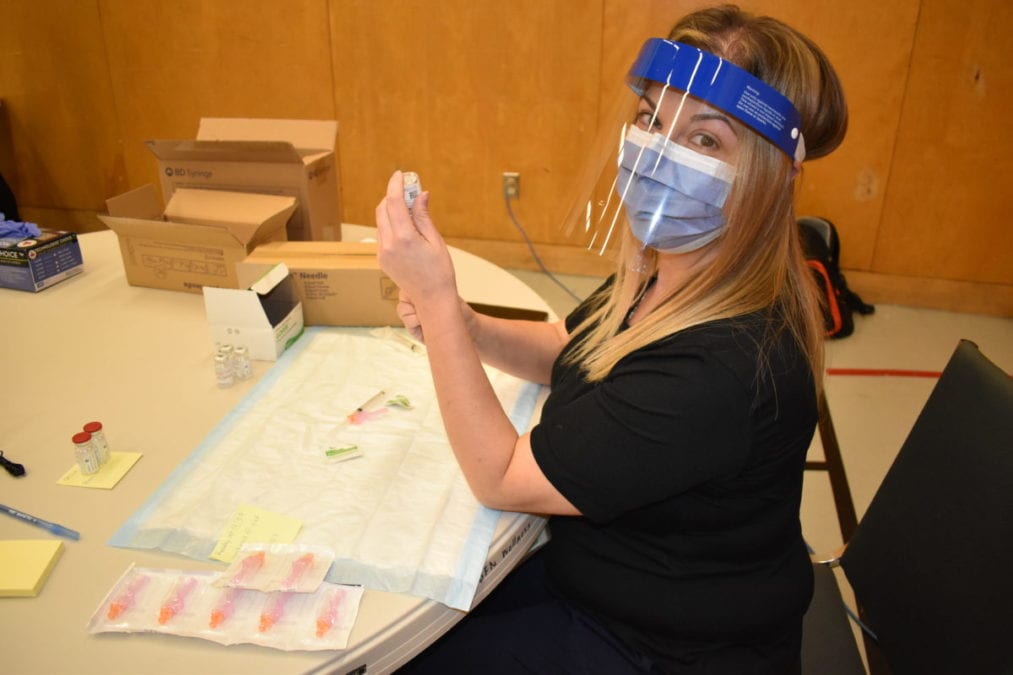 Lead nurse Diana Ollerhead draws the Moderna vaccine into a syringe for the other nurses to use at the vaccination clinic. Blair McBride/NNSL photo