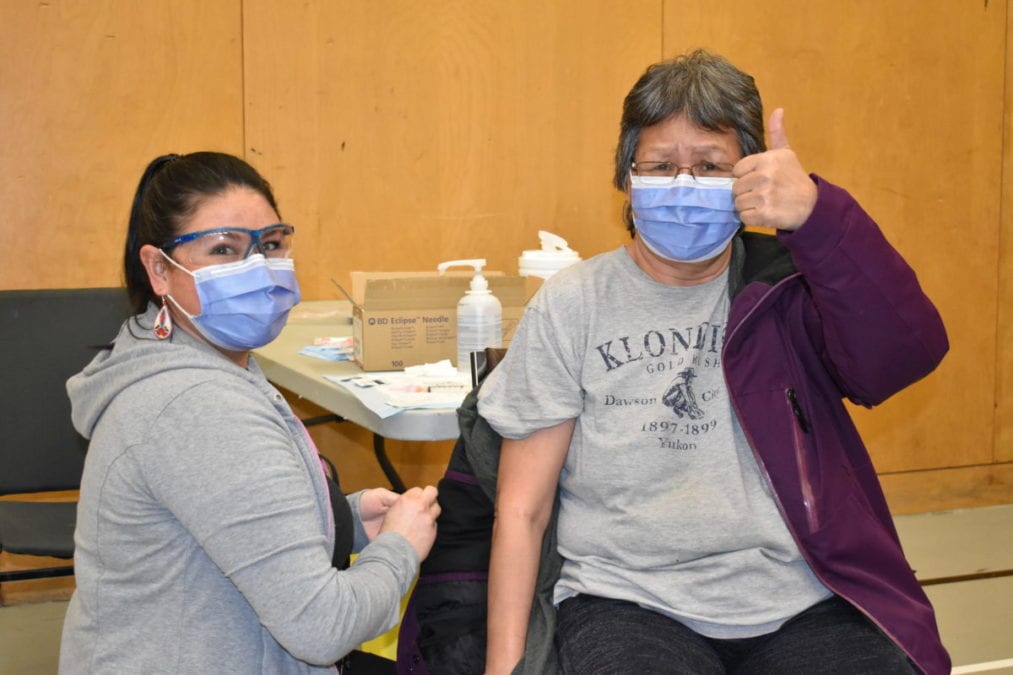 Rielle Nakehk’o, left, prepares to send off Marilyn Colin after she received her first dose of the Covid-19 vaccine on Friday in Dettah. Blair McBride/NNSL photo