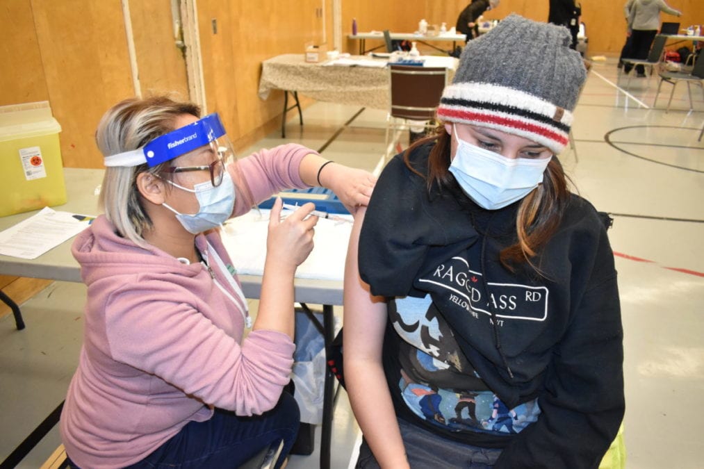 Cherie Cadiz, left, gives the Moderna vaccine to Sarah Black in the Memorial Complex gym in Dettah. Blair McBride/NNSL photo