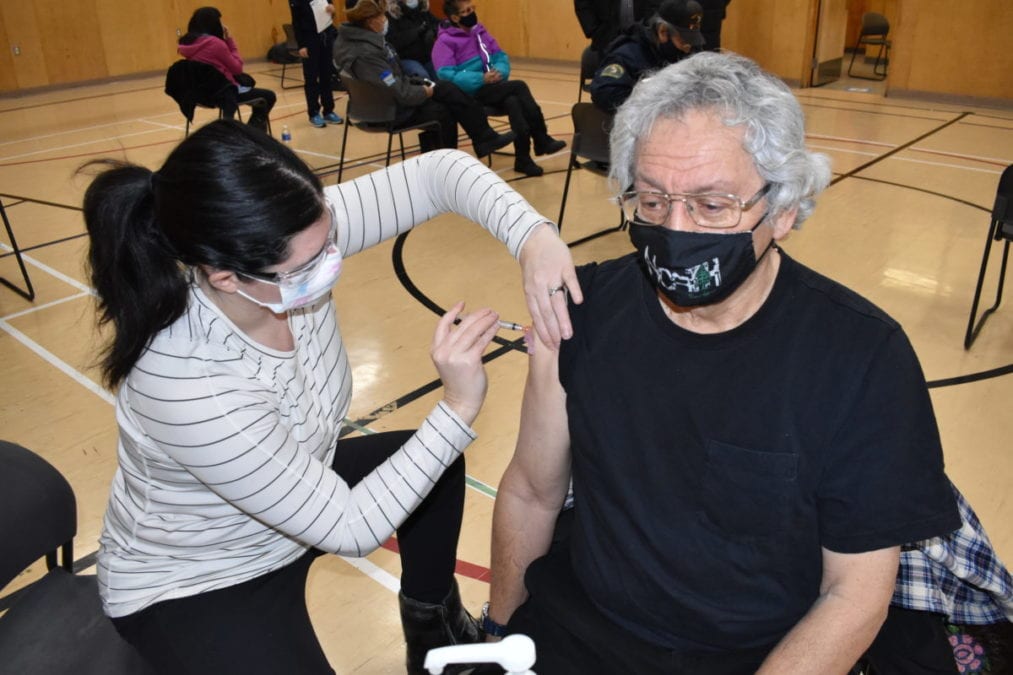 Chelsea Donaldson, left, gives a dose to George Erasmus, former chief of the Assembly of First Nations and Dene Nation. Blair McBride/NNSL photo
