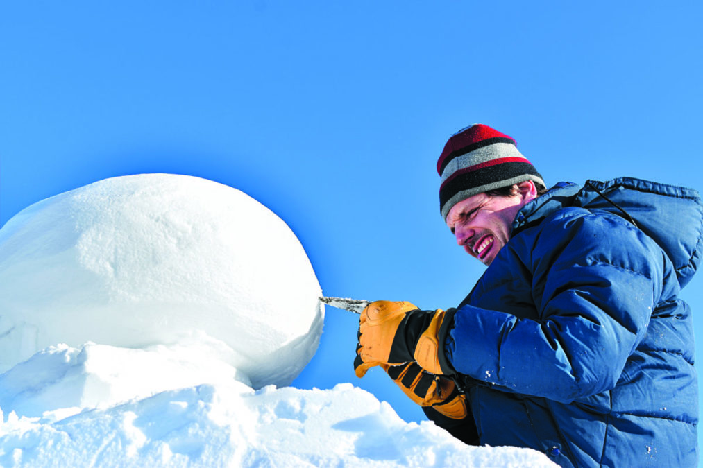 Eric Heitmann bites his tongue and squints as he perfects his international snow carving competition on Yellowknife Bay on Feb. 20. NNSL photo