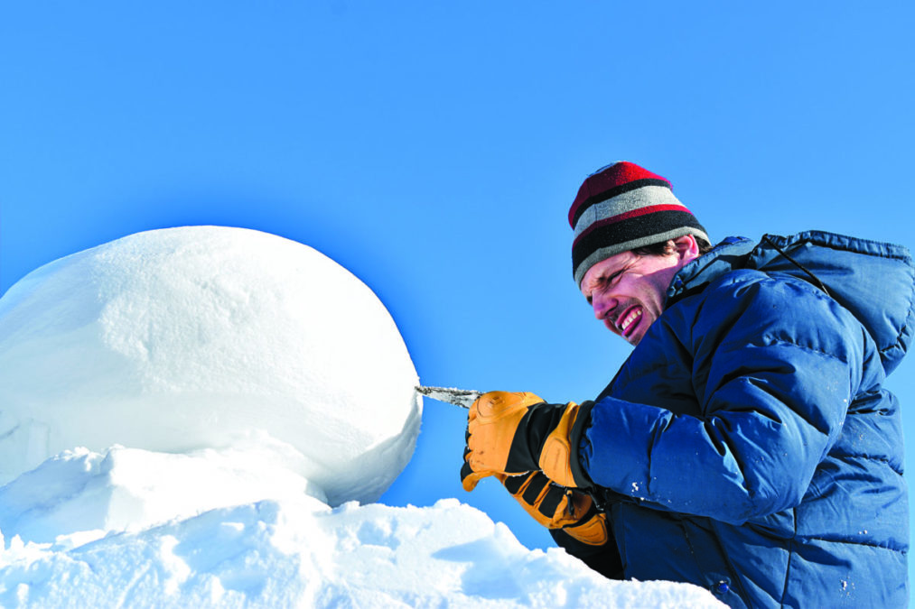 Eric Heitmann bites his tongue and squints as he perfects his international snow carving competition on Yellowknife Bay on Feb. 20. ºÚÁϳԹÏÍø photo