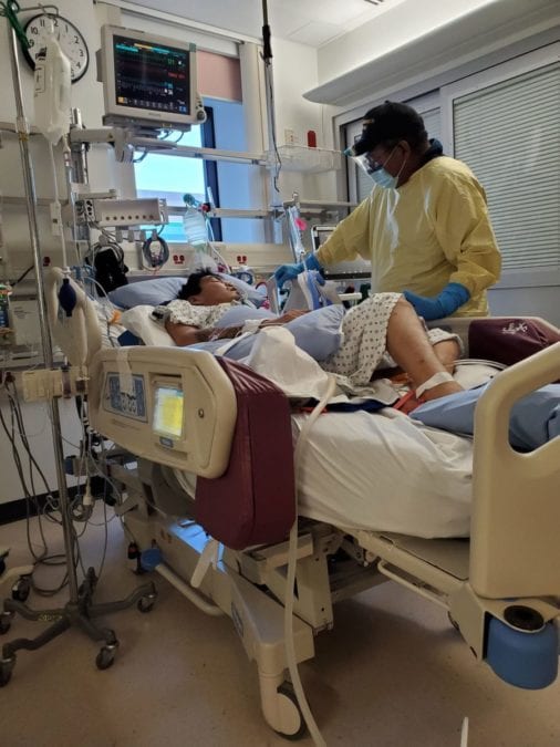 Myrine Kafkwi, left, lies in an induced coma in the ICU of the University of Alberta Hospital in Edmonton, as his father Wayne Kakfwi stands beside him. photo courtesy of Dolly Pierrot