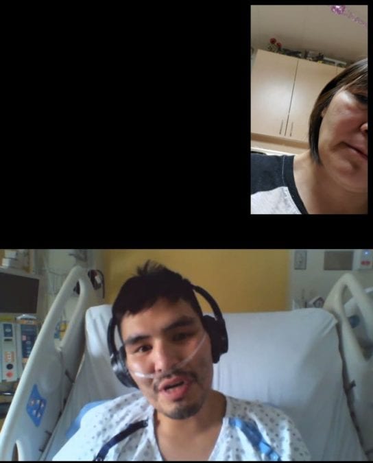 Myrine Kafkwi, bottom, speaks through video chat from his hospital bed in Edmonton with his mother Dolly Pierrot, in December. photo courtesy of Dolly Pierrot