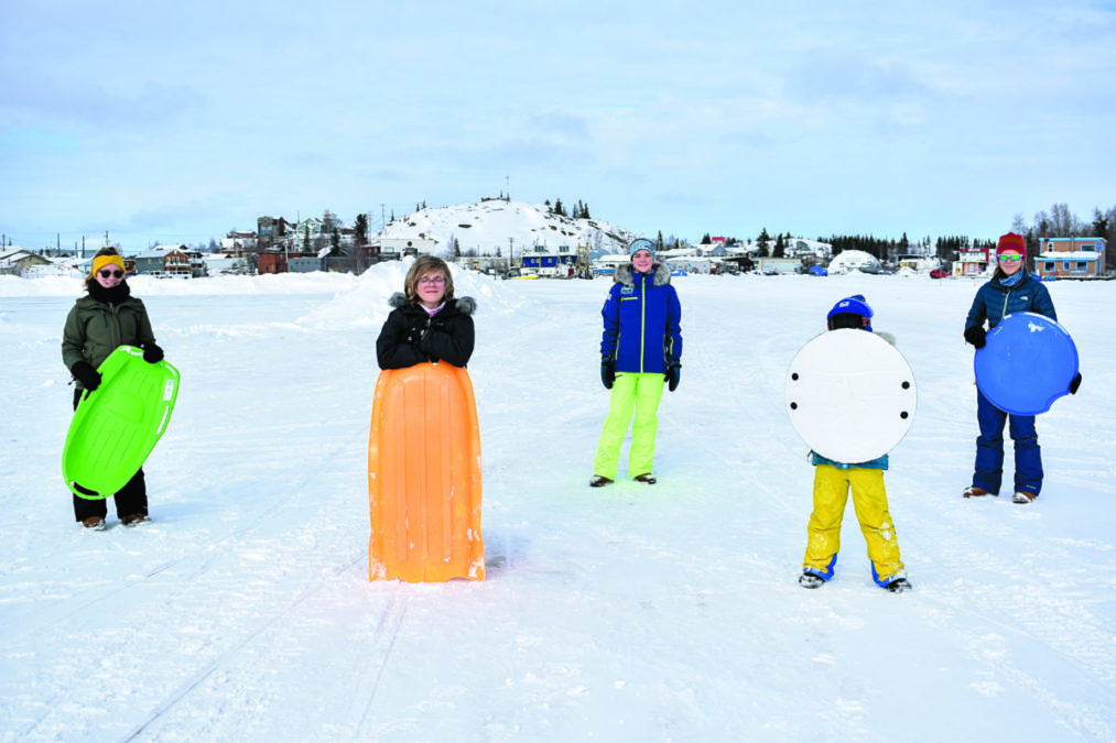 Monika Schroeder, left, Zachary Young, Kira Young, Solomon Young and Sarah Cook pose during their "adventure sledding" trip on March 22. "It’s like hiking and sliding down any hill we find. We’ll go to Jolliffe Island. We were adventure skiing in Burwash earlier,” said Cook. NNSL photo