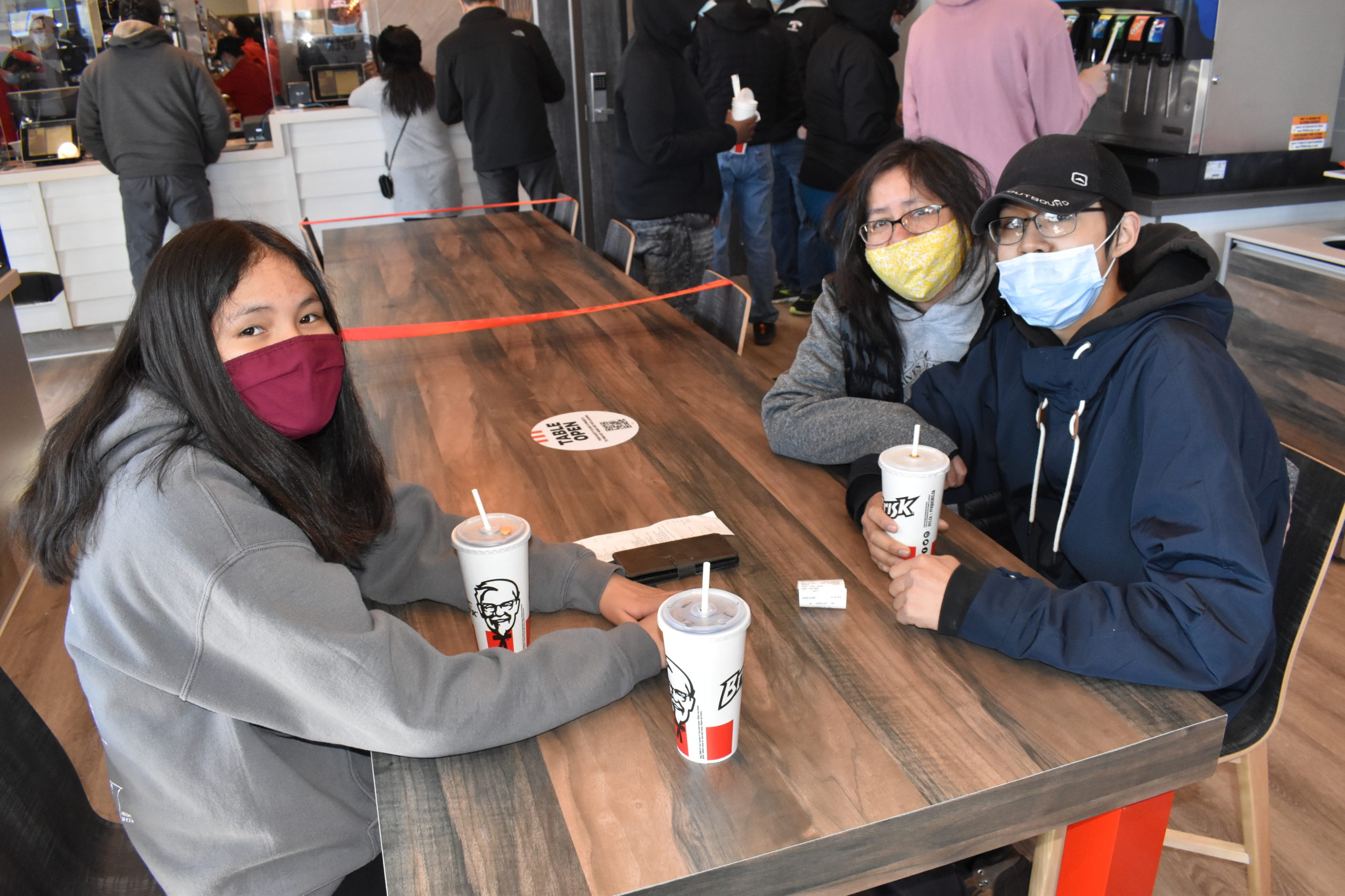 Madison Liske, left, Tina Tristan Madison and Tristan Liske wait for their chicken orders on May 3. "Its good KFC came back. Lots of communities like it," said Madison Liske. Blair McBride/窪蹋勛圖厙 photo