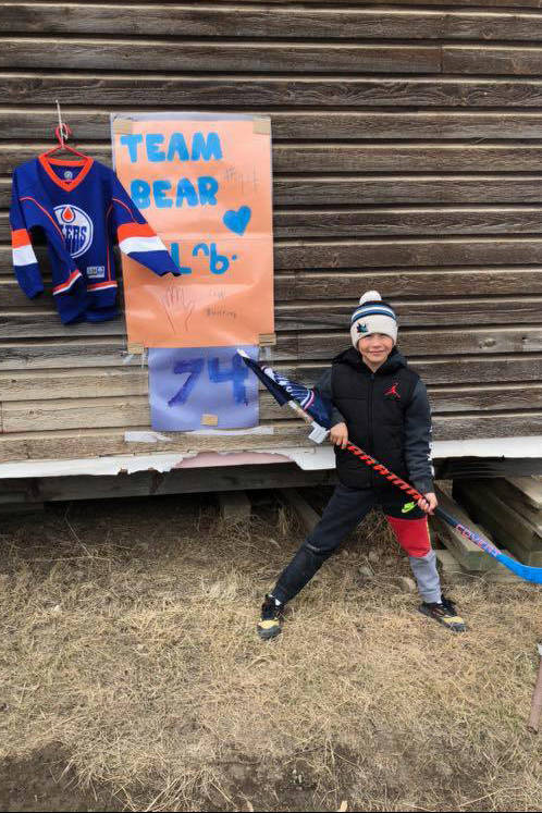 Eight-year-old Anderson Storr shows his support for Edmonton Oiler Ethan Bear with a poster and jersey on display at his home in Aklavik. Storr was one of many in the Beaufort Delta who stepped up to show support for the hockey player after a spate of racist attacks were levied against him over social media. photo courtesy of Deana Greenland