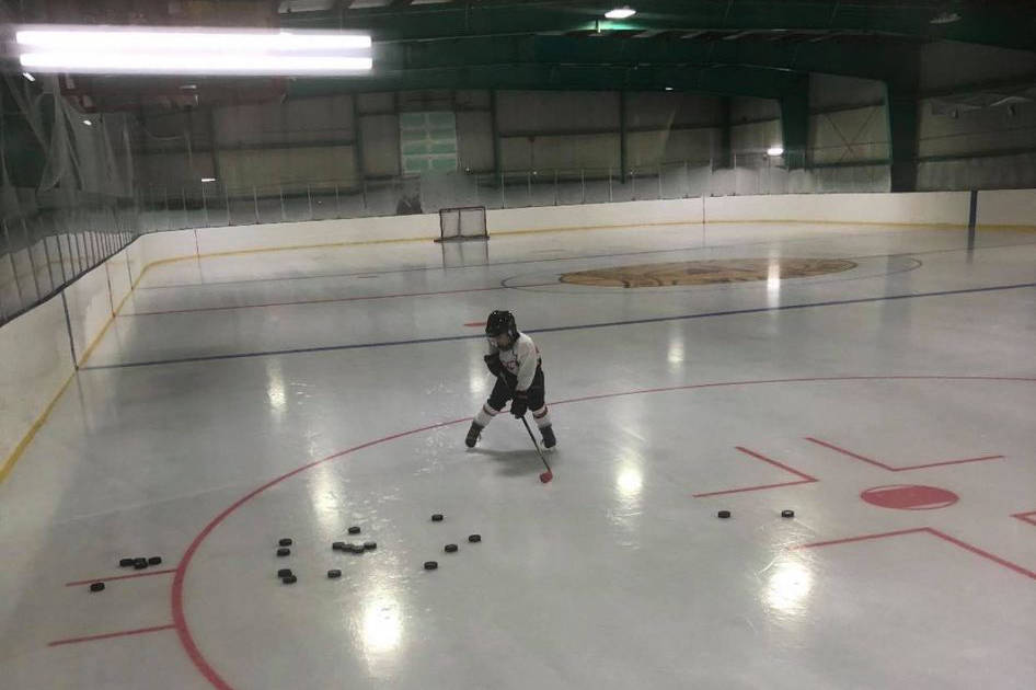 Anderson Storr practices his stickwork at the Aklavik arena. Storr said he was really bothered by the racism directed at NHL player Ethan Bear so he made a poster to show his support for the Cree Edmonton Oiler. photo courtesy of Deana Greenland