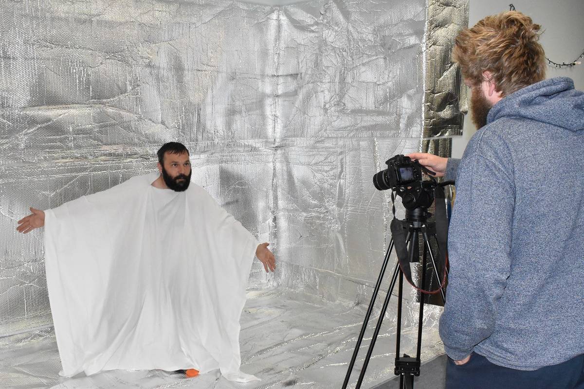 Martin Rehak, left, performs a scene using reflective insulation for background, as Harrison Roberts films inside Second Space studio, on July 13. The silver is your mind. The white robe is a representation of yourself in your mind, said Rehak. Blair McBride/窪蹋勛圖厙 Photo