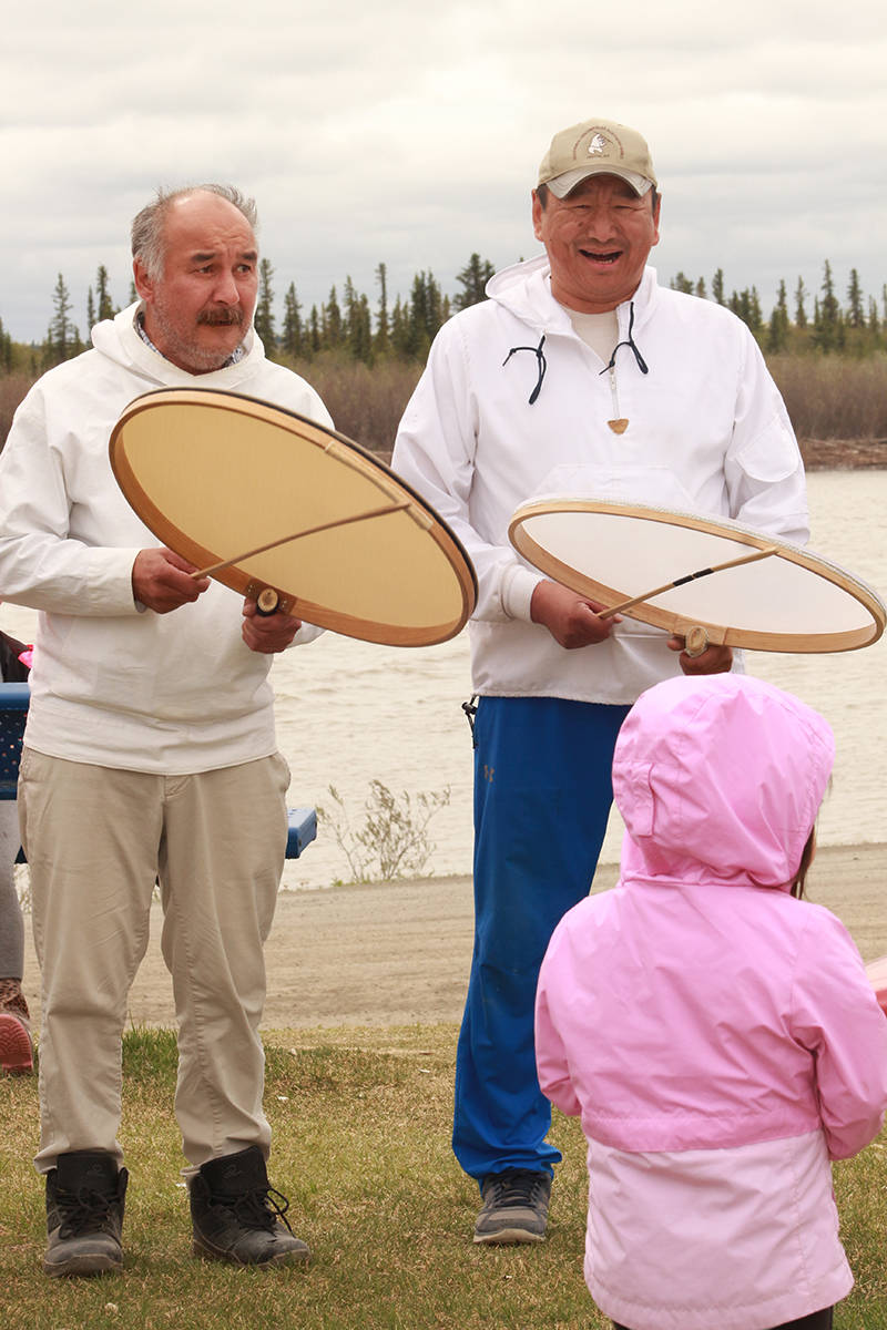 Inuvialuit Drum Dancers Nungki Brian Rogers and Hans Lennie share a laugh as a child busts a move to their beats. For many of the Elders at the memorial walk, knowing children today would not experience the horrors of Canadas Residential Schools was a wonderful feeling. Eric Bowling/窪蹋勛圖厙 photo