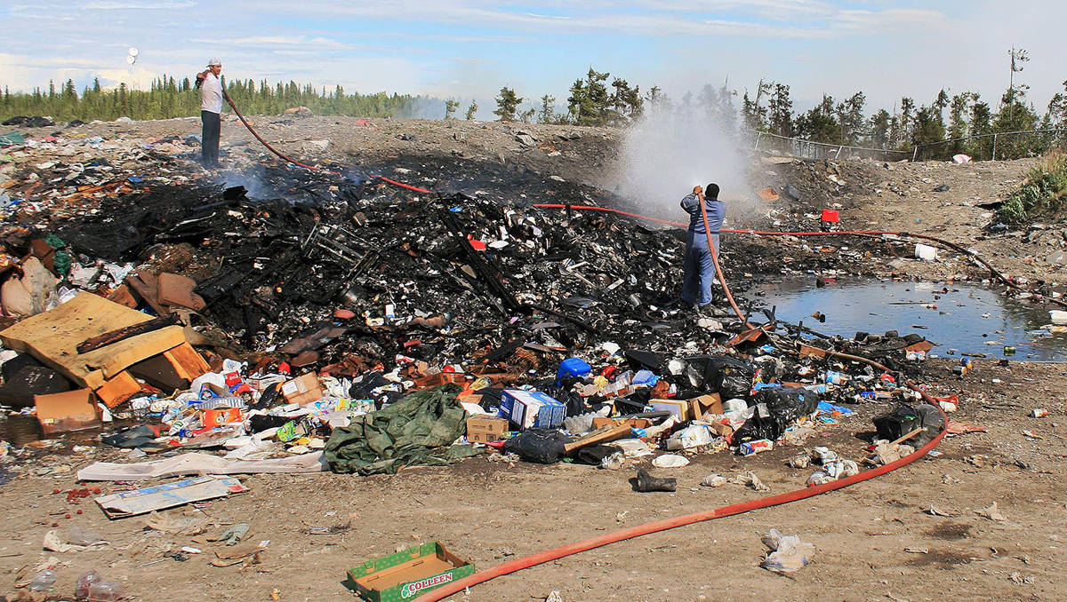 Firefighters are fighting a fire at the Tsiigehtchic landfill. Initial suppression action by local bylaw and Environment and Natural Resources officers is underway, supported by Tsiigehtchic Community Corporation water trucks. photo courtesy of Lawrence Norbert