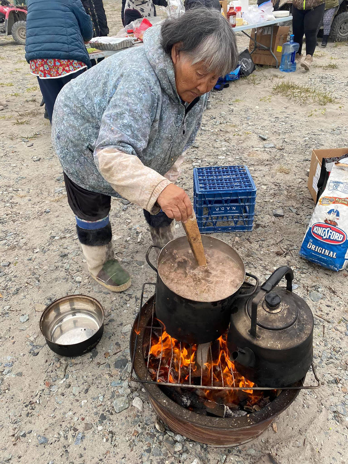 Kate Inuktalik stirring Caribou Soup during the Ulukhaqtuuq Youth Wellness Gathering July 25-30. While participants learned several tradition skills including making mittens and drum dancing, a huge part of the trip focused on traditional foods. Photo courtesy of Western Arctic Youth Collective