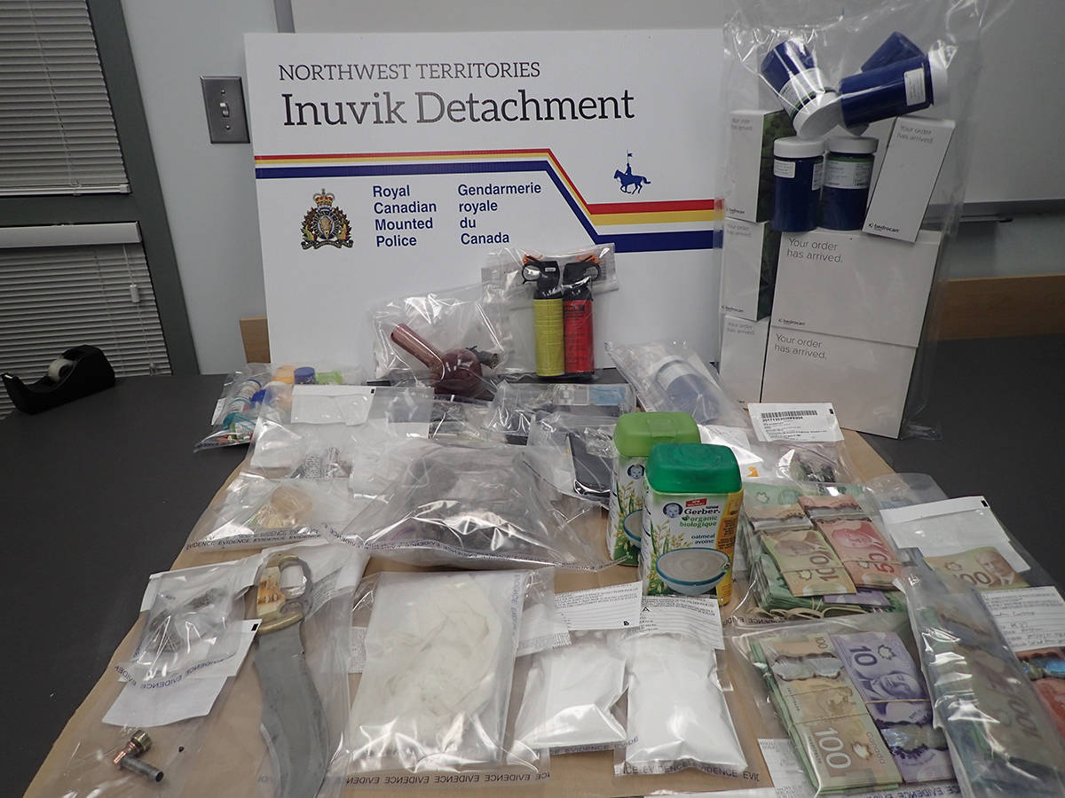 A photo of drugs, cash and bear spray RCMP seized from 22 Kugmallit Road on Oct. 20, 2017 after executing a search warrant. The trial of the man accused of being the owner of the items wrapped up Aug. 19 but a verdict wont be made until later in the year. 窪蹋勛圖厙 file photo